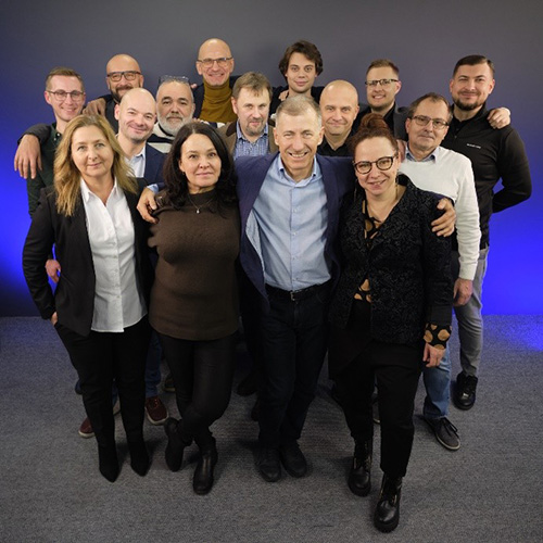 a closeknit group of colleagues stand shoulder to shoulder